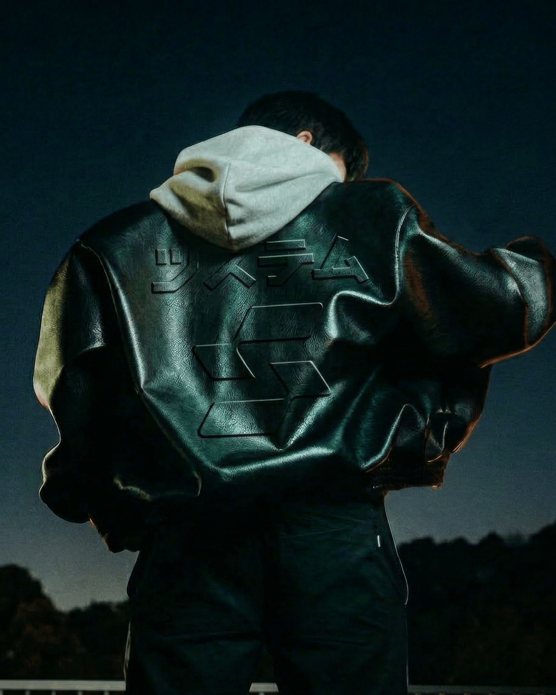 Mockup of a person wearing a jacket with the Sazabi mark and katakana embossed on the back